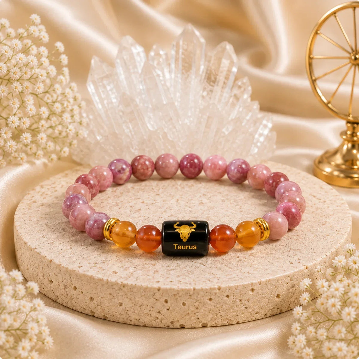 Orange carnelian beads and golden tiger eye beads laid beside a single rudraksha bead on a light wooden desk